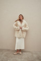 Curly double-sided sheepskin coat of white color made of natural sheepskin in the OVERSIZE style