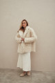 Curly double-sided sheepskin coat of white color made of natural sheepskin in the OVERSIZE style