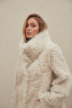 A stylish double-sided sheepskin coat made of natural white sheepskin