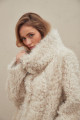 A stylish double-sided sheepskin coat made of natural white sheepskin