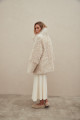 A stylish double-sided sheepskin coat made of natural white sheepskin