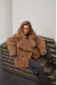 Stylish two-sided sheepskin coat made of natural sheepskin in camel color