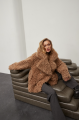 Stylish two-sided sheepskin coat made of natural sheepskin in camel color