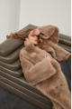 Long sheepskin coat made of natural cashmere lamb in brown color