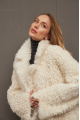 Long curly two-sided sheepskin coat of white color made of natural sheepskin in OVERSIZE style