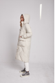 Long white women's down jacket with natural filler in the style of OVERSIZE