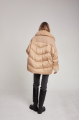 Women's down jacket of beige color with mink fur and decorative knitting and natural filler