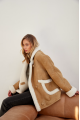 Stylish sand-colored sheepskin coat made of natural sheepskin