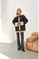 Stylish vintage sheepskin coat of black color made of natural sheepskin in VINTAGE style