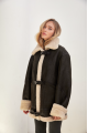 Stylish vintage sheepskin coat of black color made of natural sheepskin in VINTAGE style