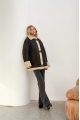 Stylish vintage sheepskin coat of black color made of natural sheepskin in VINTAGE style