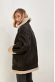 Stylish vintage sheepskin coat of black color made of natural sheepskin in VINTAGE style