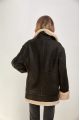 Stylish vintage sheepskin coat of black color made of natural sheepskin in VINTAGE style