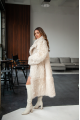 A long two-sided sheepskin coat made of milk-colored natural sheepskin