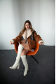 Women's sheepskin coat in VINTAGE style and a stylish combination of dark chocolate and whiskey colors