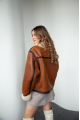 Women's sheepskin coat in VINTAGE style and a stylish combination of dark chocolate and whiskey colors