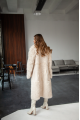 A long two-sided sheepskin coat made of milk-colored natural sheepskin