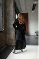 A long black sheepskin coat with a detachable collar