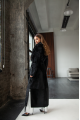 A long black sheepskin coat with a detachable collar