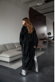 Long sheepskin coat made of natural sheepskin in black color