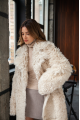 A long two-sided sheepskin coat made of milk-colored natural sheepskin