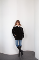 Women's black sheepskin coat made of natural sheepskin with a white mink collar