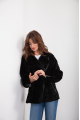 A classic sheepskin coat of black color made of natural sheepskin