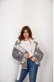 A stylish short leather jacket made of natural light gray sheepskin with white fur