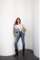 A stylish short leather jacket made of natural light gray sheepskin with white fur