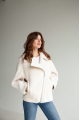 Short women's sheepskin coat made of milk-colored wool