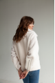 Short women's sheepskin coat made of milk-colored wool