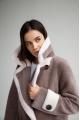 Women's coat of ash-pink color made of ECO fur