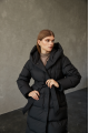 Women's long down jacket of black color with natural filling