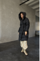 Women's long down jacket of black color with natural filling