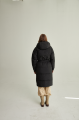 Long women's down jacket of black color with natural filler