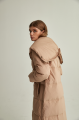 Women's long down jacket of beige color with natural filler