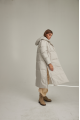 Women's long down jacket of white color with natural filler