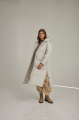 Women's long down jacket of white color with natural filler