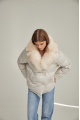 Women's down jacket of white color with fox fur and natural filler