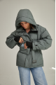 Women's short down jacket of green color with natural filler