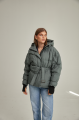 Women's short down jacket of green color with natural filler