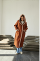 Women's long sheepskin coat of red color made of natural sheepskin