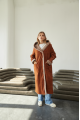 Women's long sheepskin coat of red color made of natural sheepskin