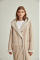 Women's long sheepskin coat of beige color made of natural sheepskin