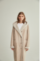 Women's long sheepskin coat of beige color made of natural sheepskin