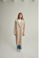 Women's long sheepskin coat of beige color made of natural sheepskin