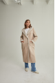 Women's long sheepskin coat of beige color made of natural sheepskin