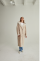 Women's long sheepskin coat of beige color made of natural sheepskin