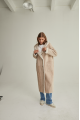 Women's long sheepskin coat of beige color made of natural sheepskin