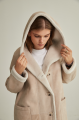 Women's long sheepskin coat of beige color made of natural sheepskin